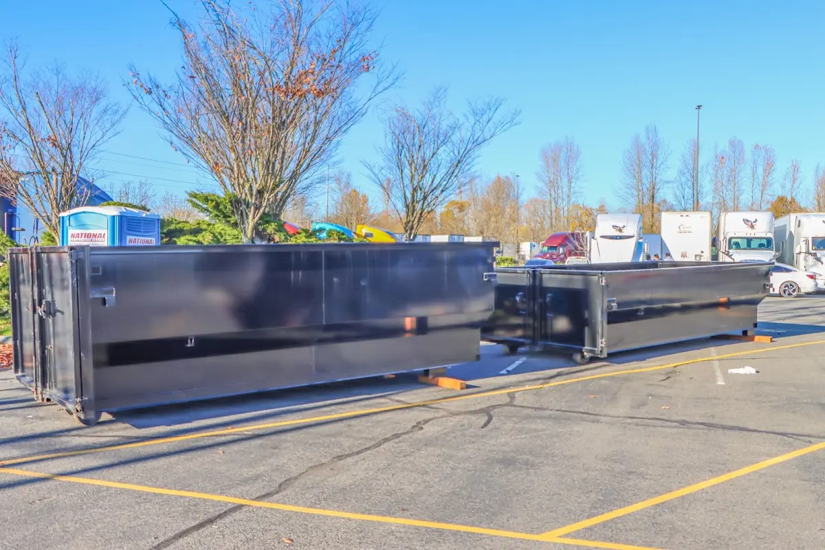 Professional dumpster rental service with roll-off container on residential driveway in Rosenberg